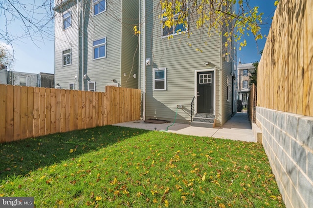 rear view of house featuring a lawn