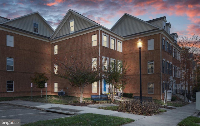 outdoor building at dusk with central air condition unit