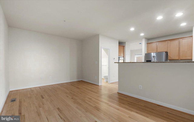 unfurnished living room featuring light wood-type flooring