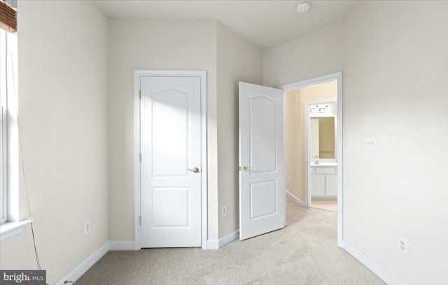 unfurnished bedroom featuring light carpet