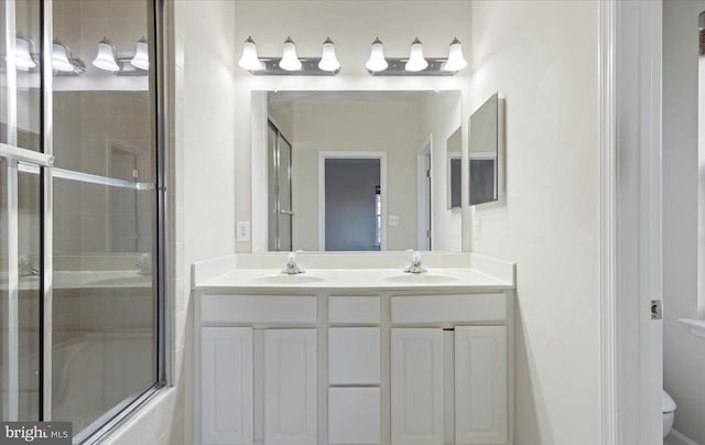 full bathroom with vanity, toilet, and bath / shower combo with glass door