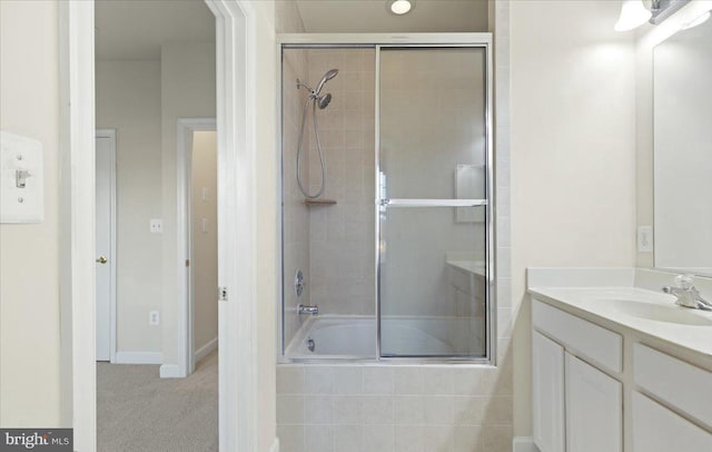 bathroom with vanity and enclosed tub / shower combo