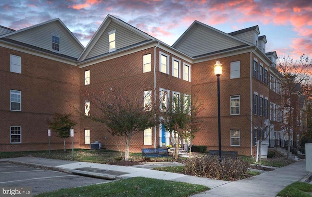 outdoor building at dusk featuring central air condition unit