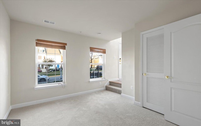 unfurnished bedroom featuring light colored carpet