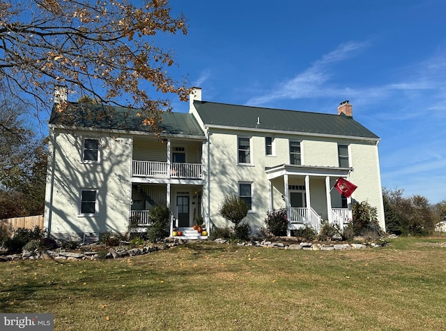 view of front of house featuring covered porch, central AC unit, a front lawn, and a balcony