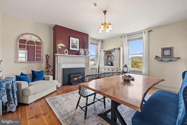 dining space with an inviting chandelier and hardwood / wood-style floors