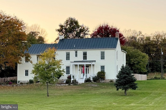 view of front of home featuring a yard and a porch