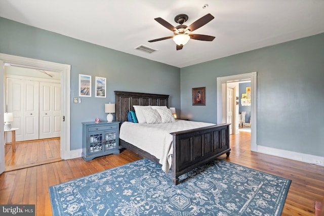 bedroom with hardwood / wood-style flooring, ceiling fan, and a closet