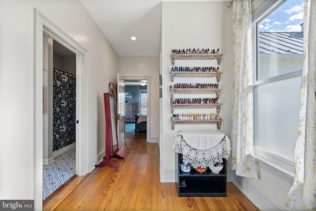 corridor with hardwood / wood-style floors