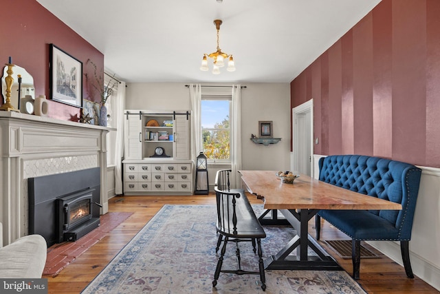 dining space with light hardwood / wood-style floors and a notable chandelier