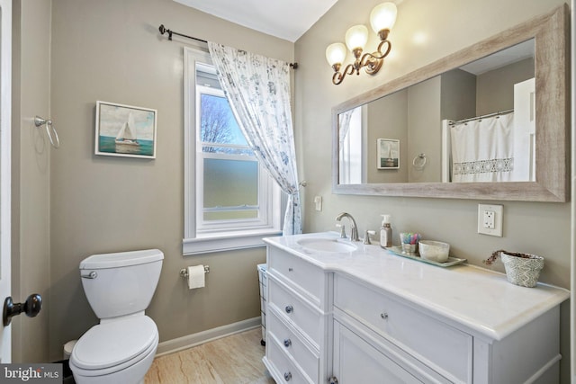 bathroom with wood-type flooring, vanity, and toilet