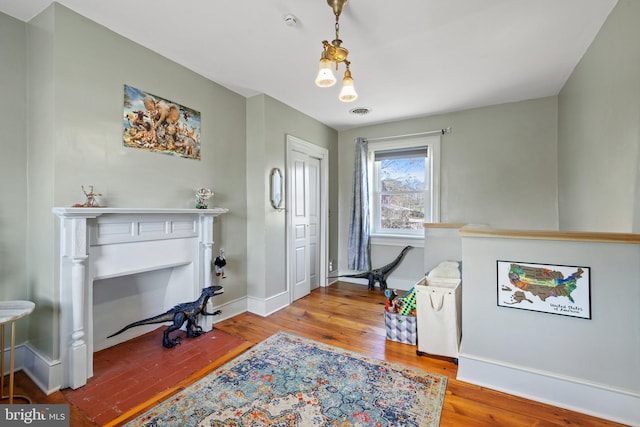 interior space with hardwood / wood-style floors and a notable chandelier