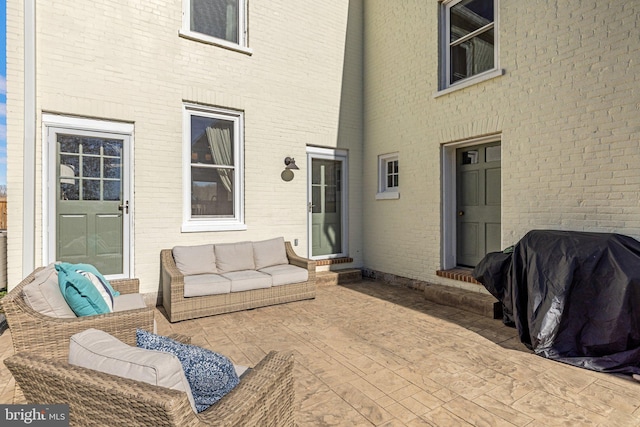 view of patio with outdoor lounge area and grilling area