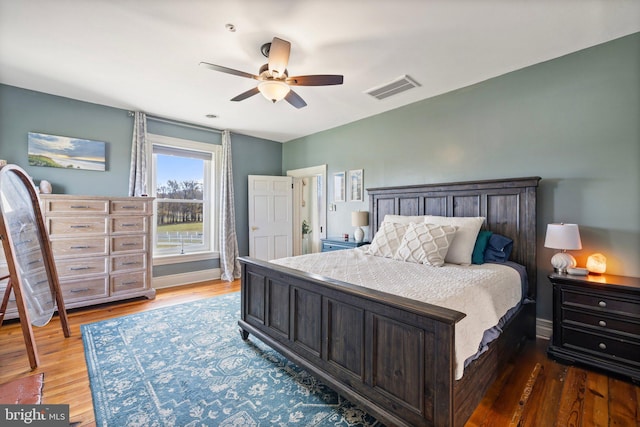 bedroom with dark wood-type flooring and ceiling fan