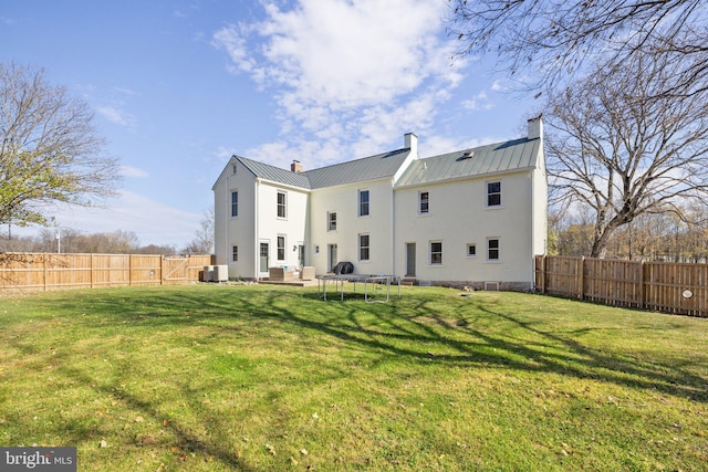 rear view of house featuring cooling unit, a patio, and a yard