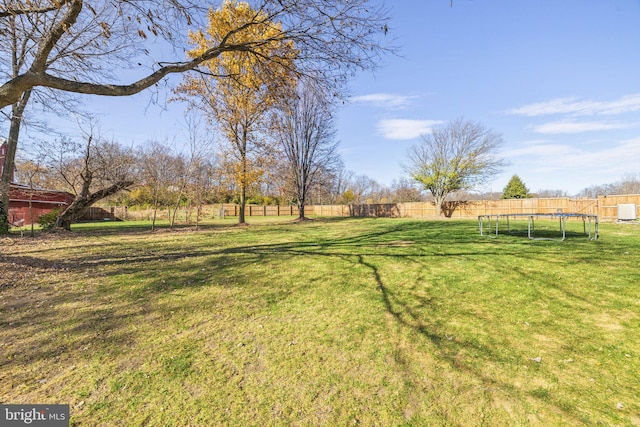 view of yard featuring a rural view and a trampoline