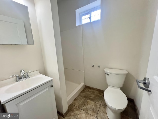 bathroom featuring toilet, vanity, a shower, and tile patterned floors