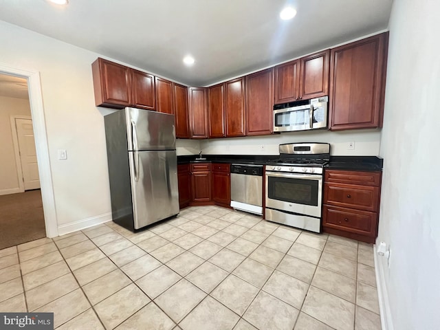 kitchen featuring light tile patterned flooring and stainless steel appliances