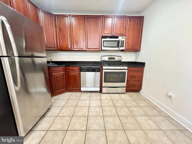 kitchen featuring sink, stainless steel appliances, and light tile patterned floors