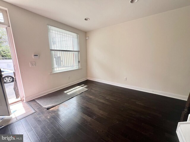 empty room featuring dark wood-type flooring