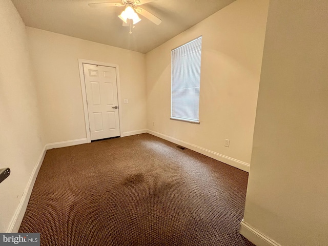 carpeted spare room with ceiling fan