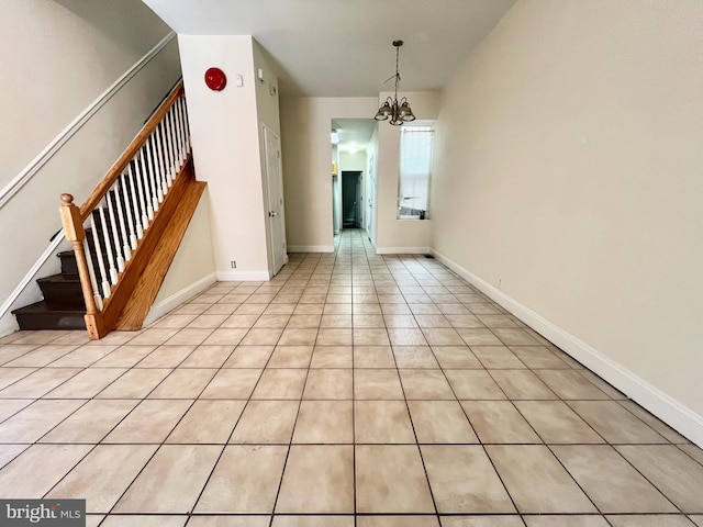 unfurnished dining area featuring light tile patterned flooring and a chandelier