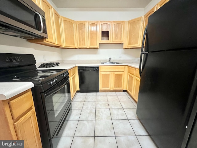 kitchen featuring black appliances, sink, and light brown cabinetry