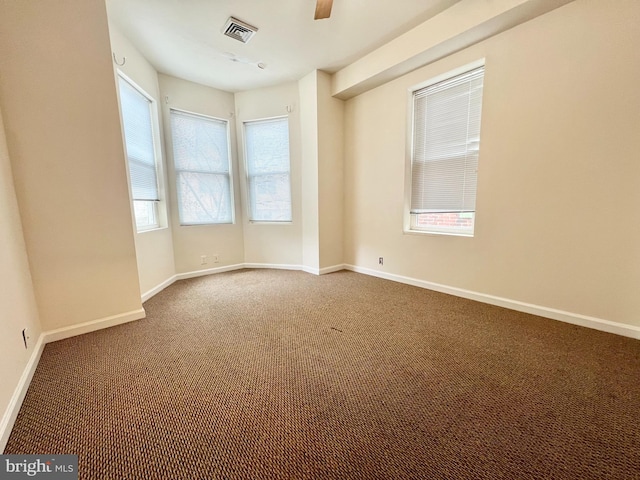 carpeted empty room featuring a healthy amount of sunlight