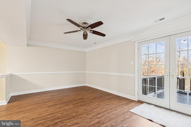 empty room with ceiling fan, french doors, wood-type flooring, and ornamental molding