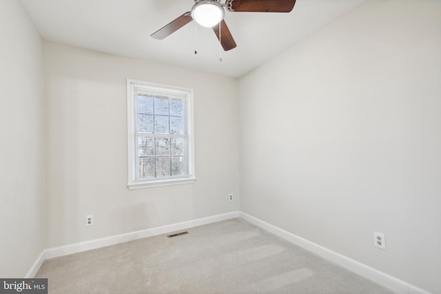 spare room with light carpet and ceiling fan