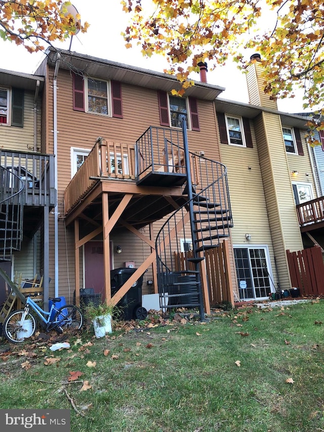 back of house featuring a balcony