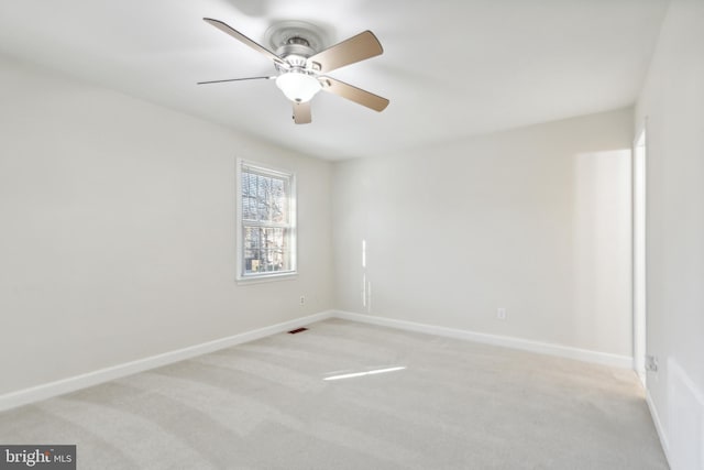 spare room with light carpet and ceiling fan