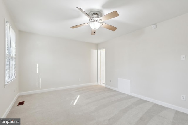 carpeted empty room featuring ceiling fan