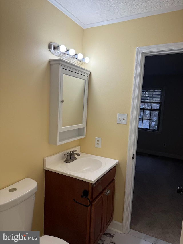 bathroom featuring vanity, toilet, and a textured ceiling