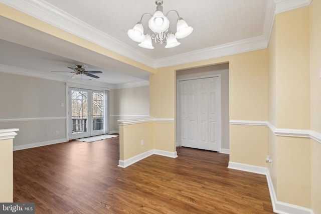 unfurnished dining area with dark hardwood / wood-style flooring, ceiling fan with notable chandelier, and ornamental molding