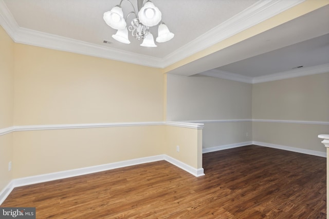 empty room with ornamental molding, dark wood-type flooring, and a chandelier