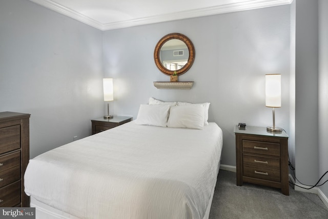 bedroom with ornamental molding and dark colored carpet