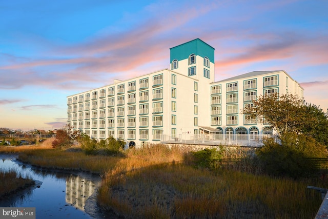 view of outdoor building at dusk