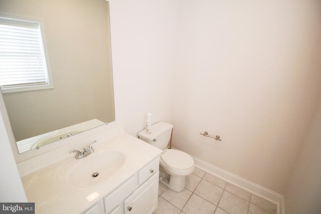 bathroom with toilet, tile patterned flooring, and vanity