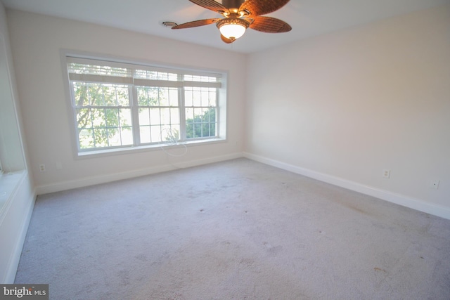 unfurnished room with ceiling fan and light colored carpet