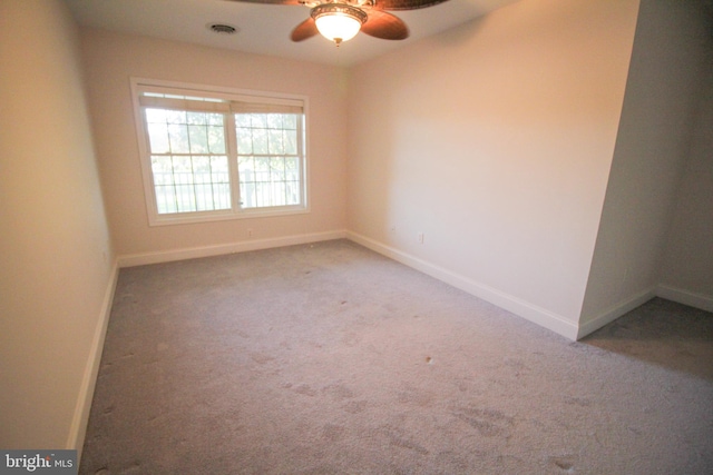 spare room featuring ceiling fan and carpet floors