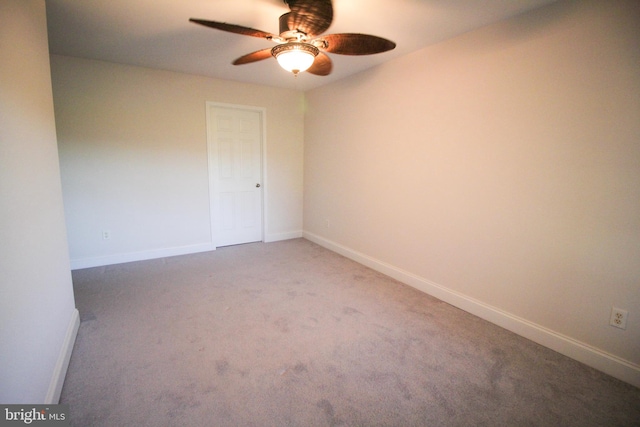 spare room with ceiling fan and carpet