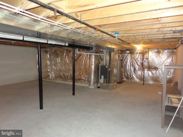 basement featuring water heater and heating unit