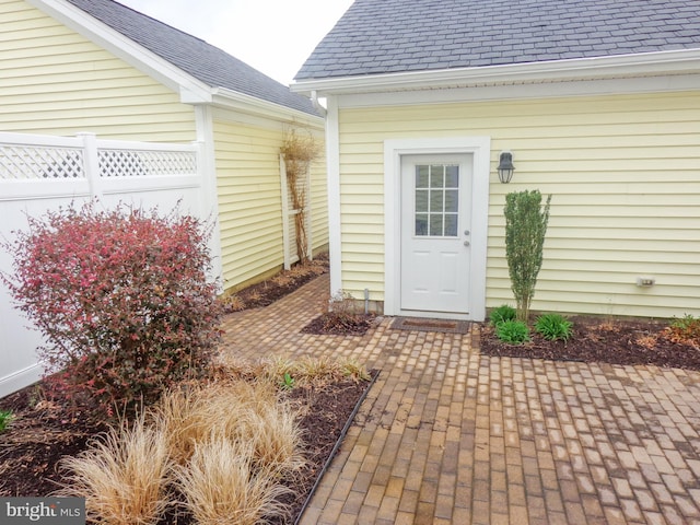 view of exterior entry with a patio area