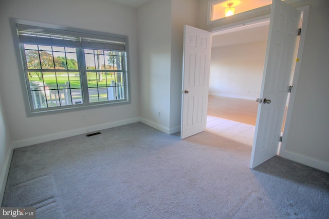 empty room with light colored carpet