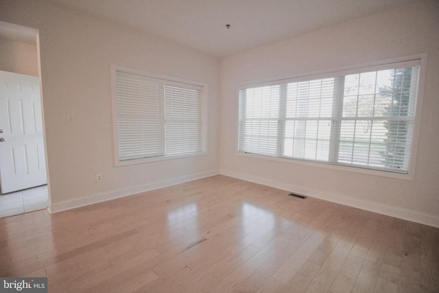 spare room with light hardwood / wood-style floors