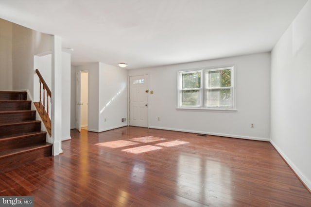 unfurnished living room with wood-type flooring