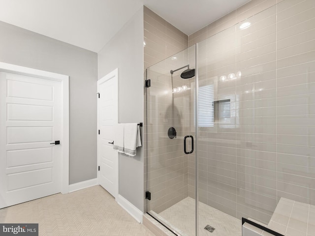 bathroom featuring a shower with shower door