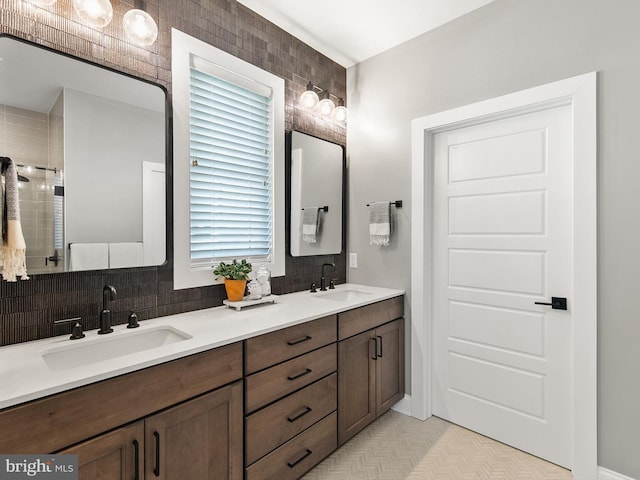 bathroom featuring vanity, decorative backsplash, and tile patterned flooring