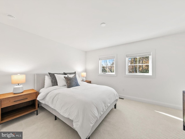 bedroom with light colored carpet